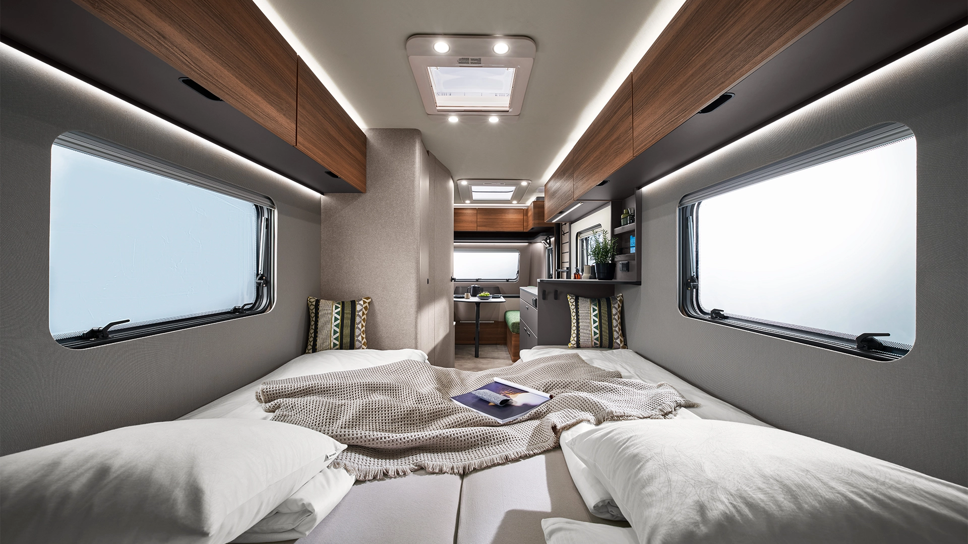 Lying area with blankets and cushions in the camper interior