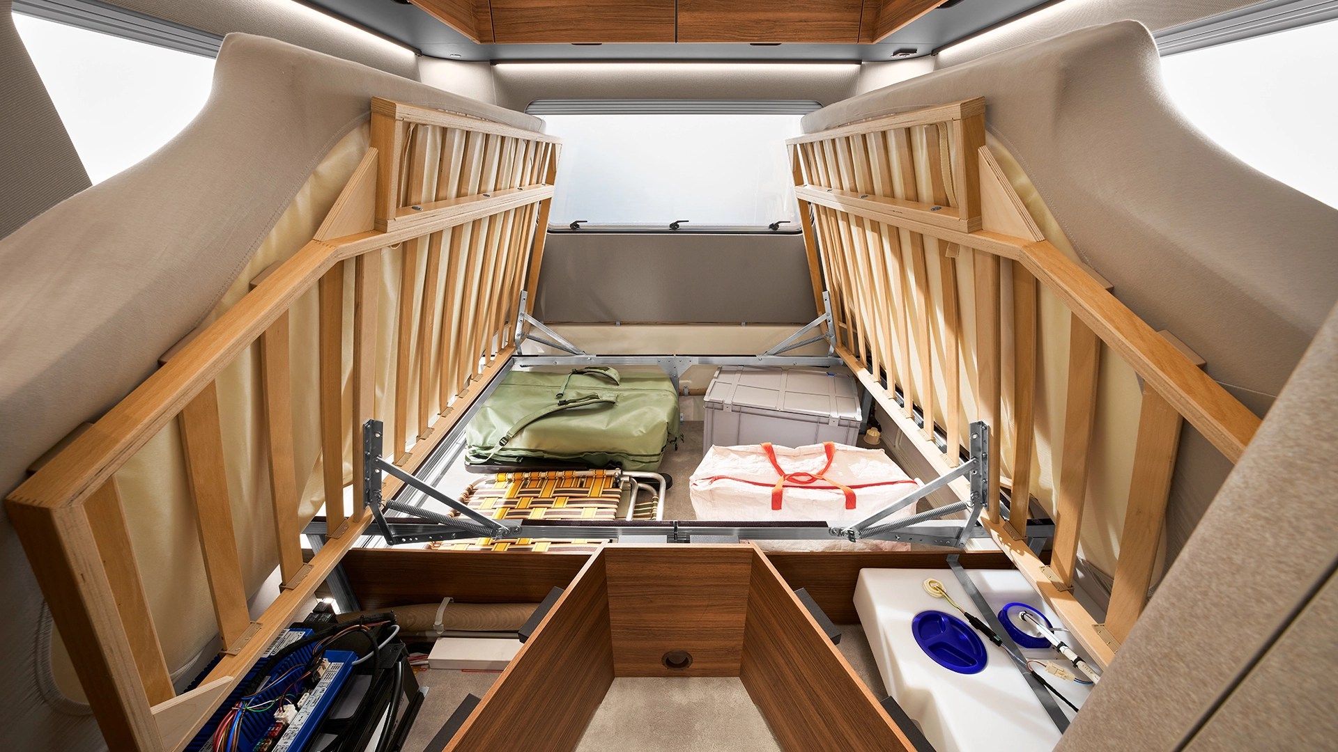 Folded-up beds provide storage space in the vehicle