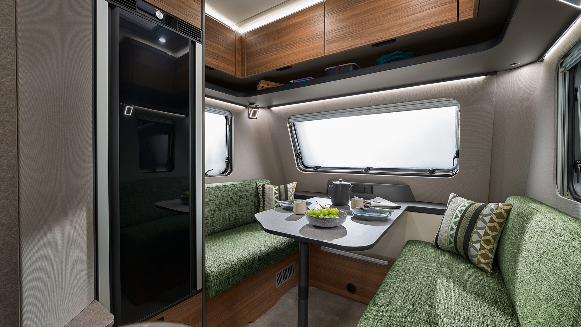 Seating area with green padded benches and set table