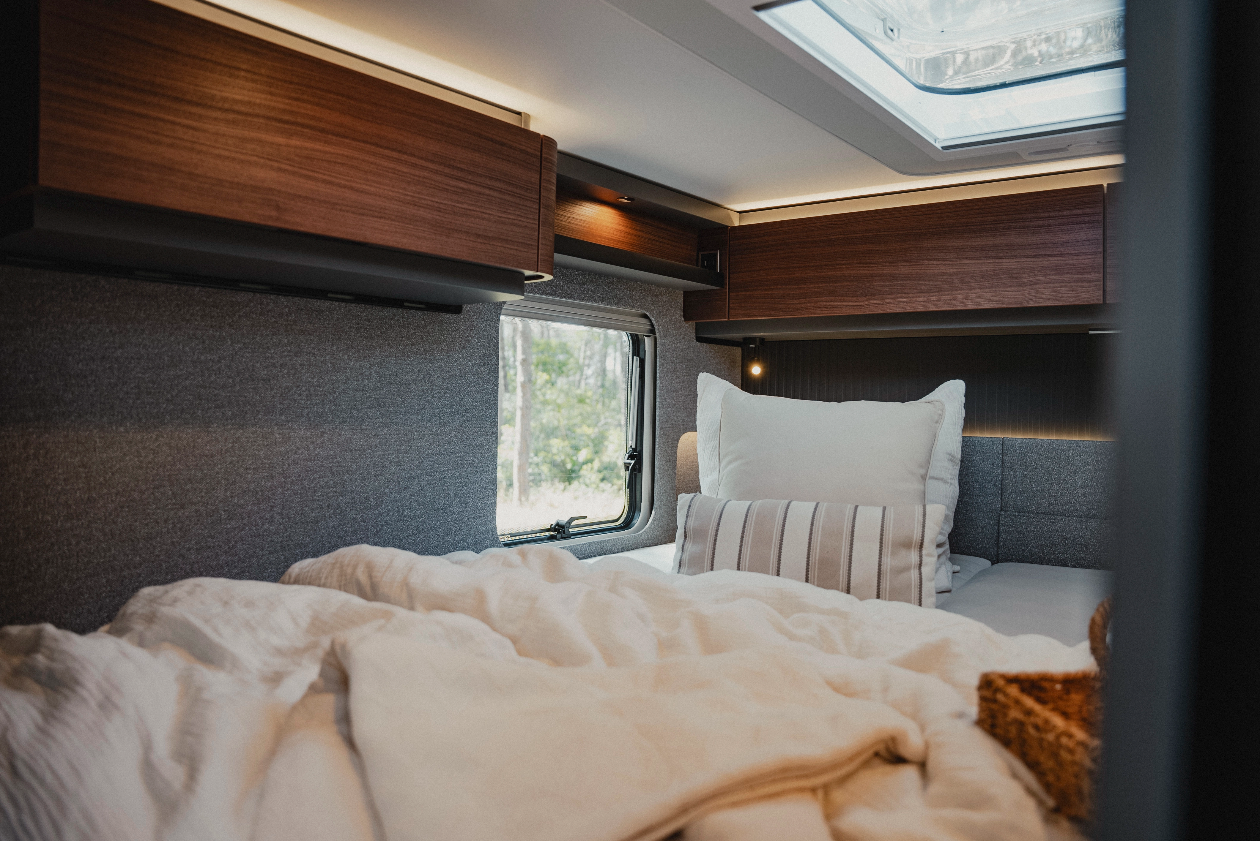 Relax in a stylish ambience: The Rochefort walnut furniture decor gives the sleeping area a warm and inviting atmosphere, while the generous windows ensure natural brightness and connect the room with the beauty of nature.