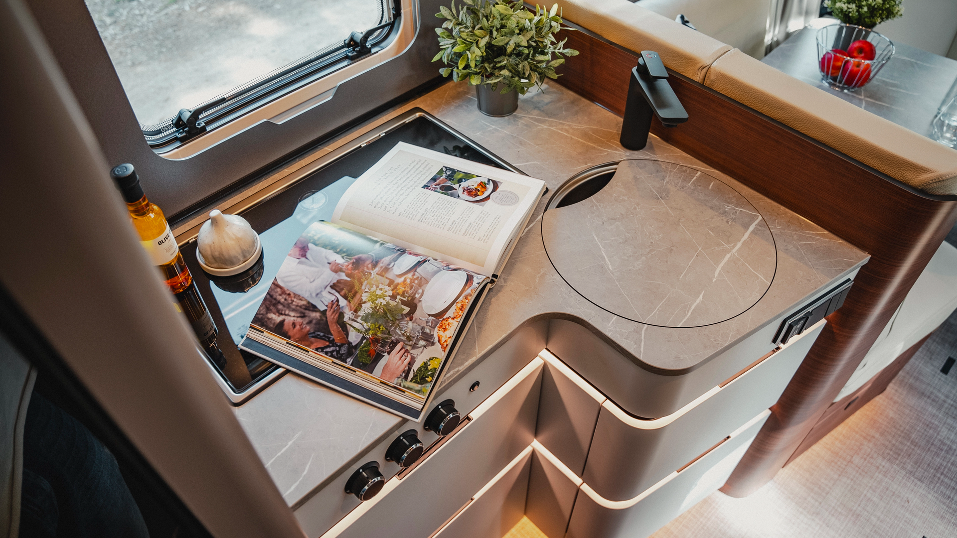 The kitchen in noble Rochefort walnut furniture decor offers space for convivial moments and culinary creativity on the go with modern surfaces and high-end equipment.