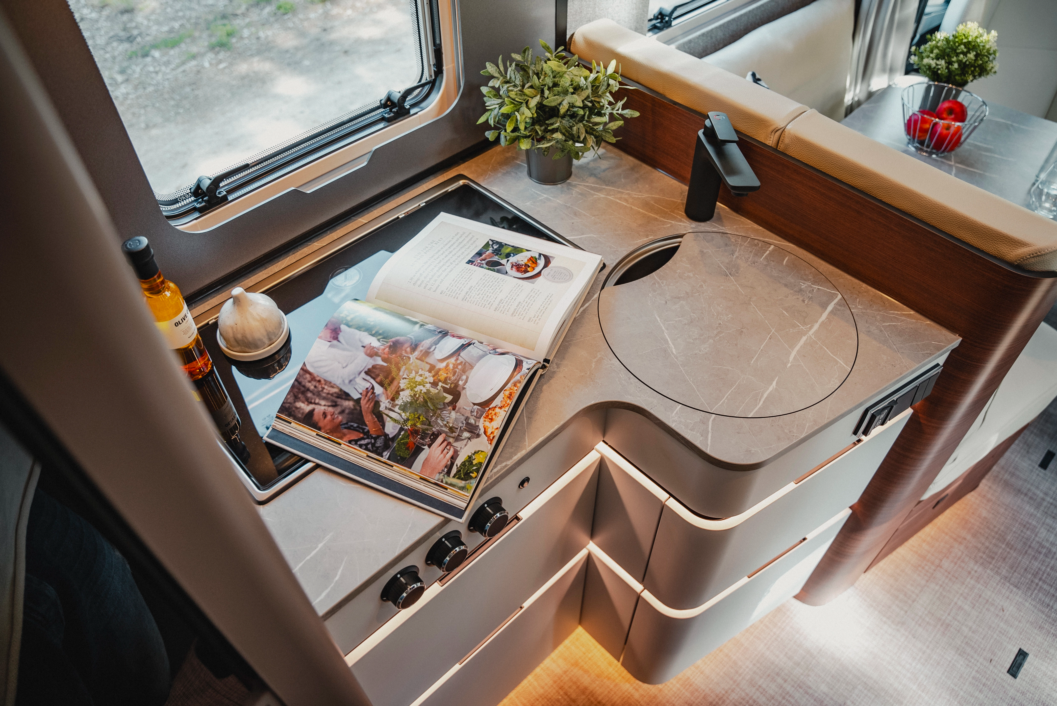 The kitchen in noble Rochefort walnut furniture decor offers space for convivial moments and culinary creativity on the go with modern surfaces and high-end equipment.