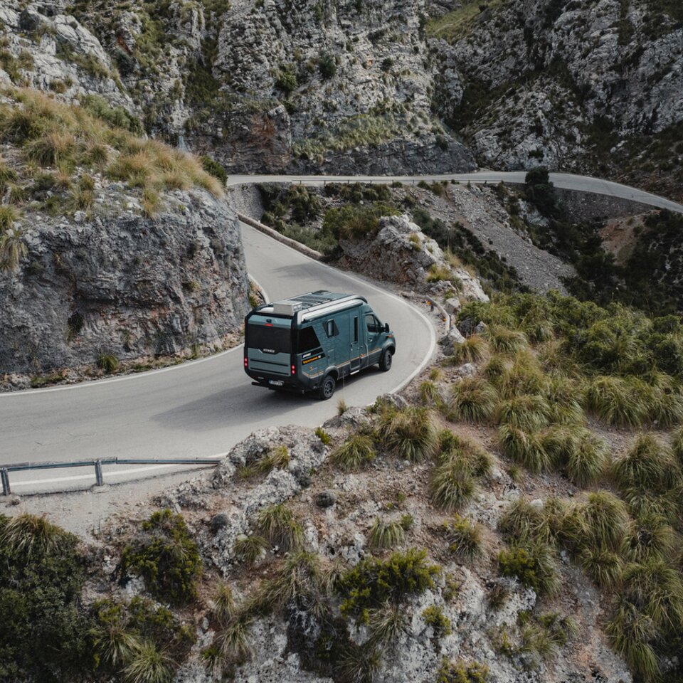 View from the rear side of the Venture S, the vehicle is driving down winding roads.